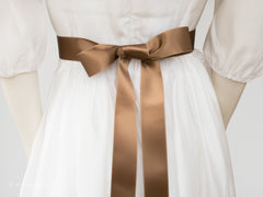 Satin ribbon for bow belts. 7 shades of brown with delicately shimmering depth of color in 3 widths. Free of harmful substances.