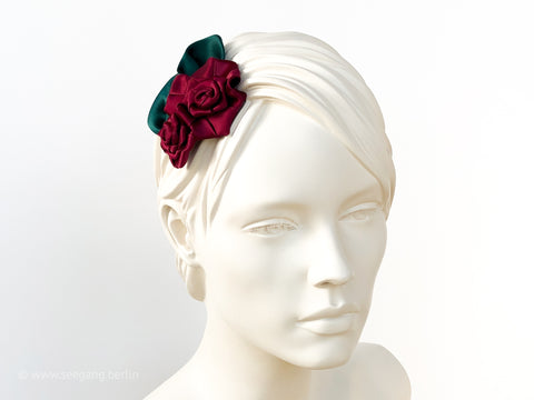 Fascinator Hair flowers with deep red Roses with dark green leaves.