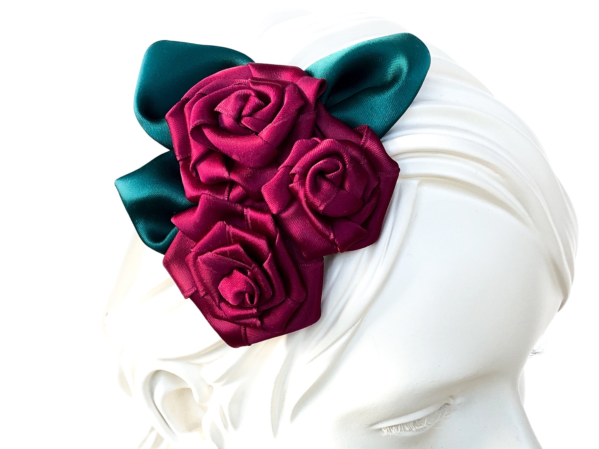 Fascinator Hair flowers with deep red Roses with dark green leaves.