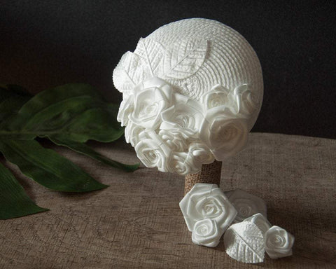 FASCINATOR - BRIDAL HEADPIECE WITH ROSES ON A BRAIDED BASE IN PURE WHITE AND OTHER SHADES © Seegang Berlin
