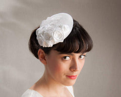 FASCINATOR - BRIDAL HEADPIECE WITH ROSES ON A BRAIDED BASE IN PURE WHITE AND OTHER SHADES © Seegang Berlin